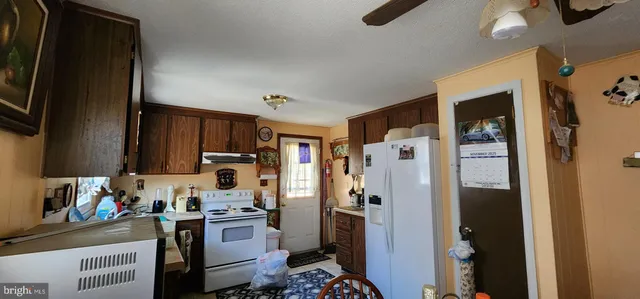 a kitchen with a refrigerator and a stove