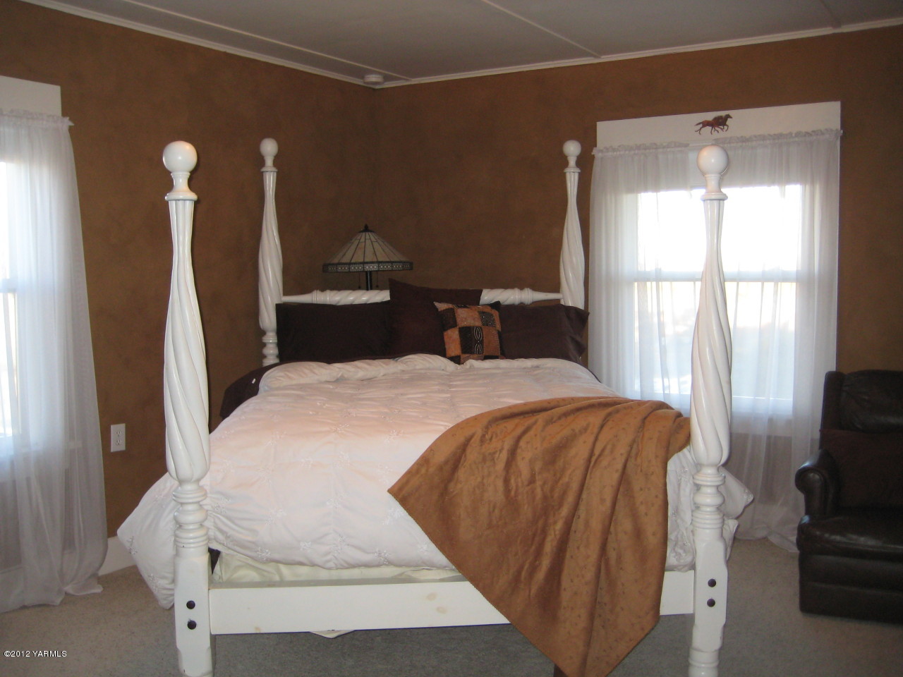 6591 West Wapato Road Wapato, WA 98951 - Photo 15 of 46 a spacious bedroom with a bed and a flat screen tv