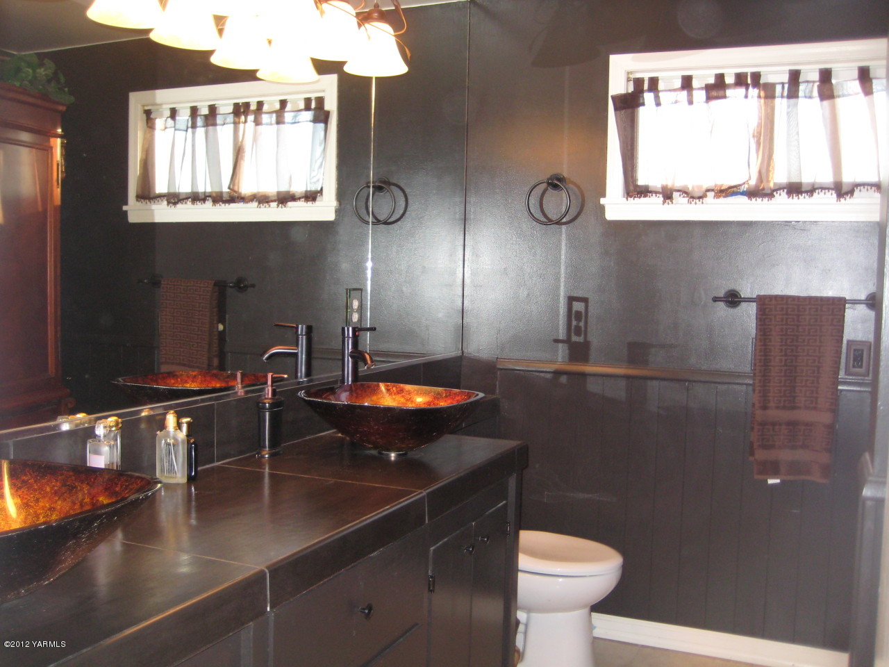 6591 West Wapato Road Wapato, WA 98951 - Photo 19 of 46 a bathroom with a toilet sink and mirror