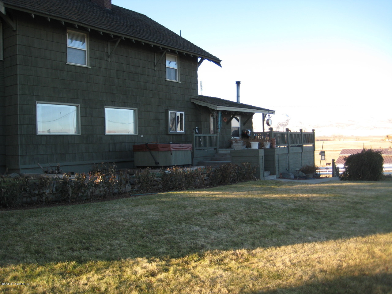 6591 West Wapato Road Wapato, WA 98951 - Photo 23 of 46 a brick house next to a yard with large trees