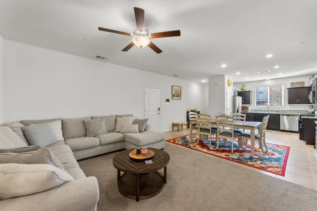 a living room with furniture and kitchen view