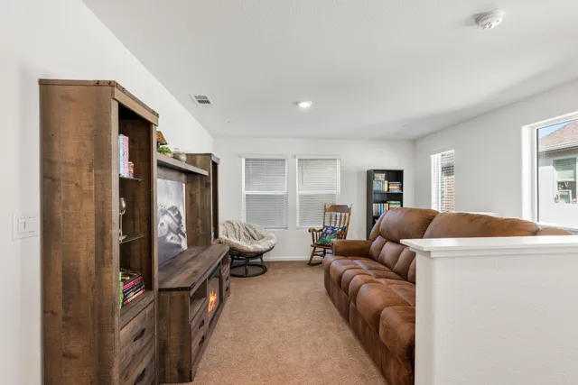 a view of a workspace with furniture and a window