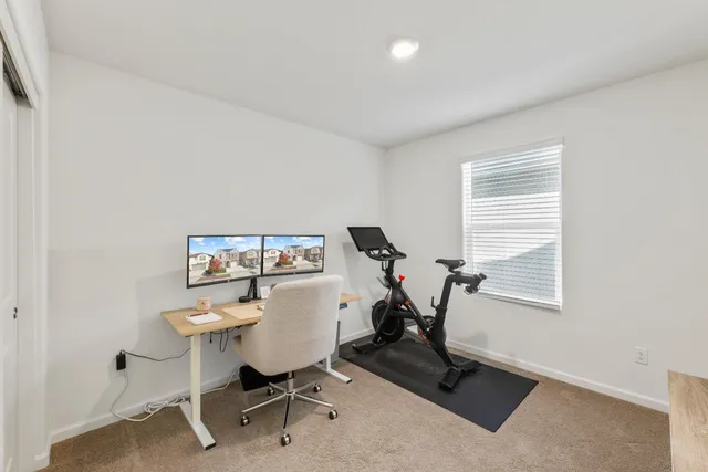a bedroom with a large bed and wooden floor