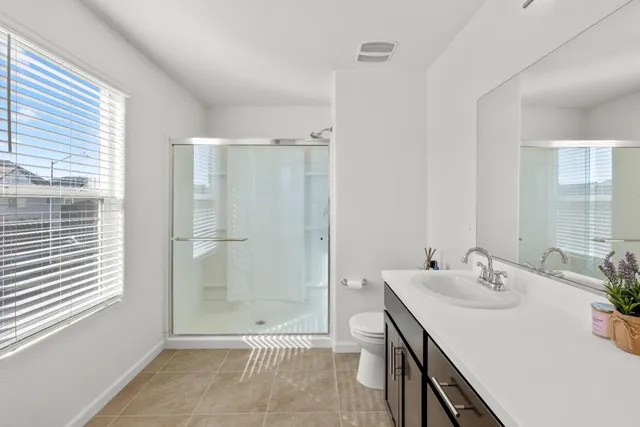 a bathroom with a sink double vanity and a mirror