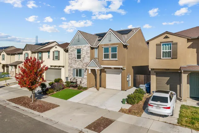 a view of house with yard and entertaining space