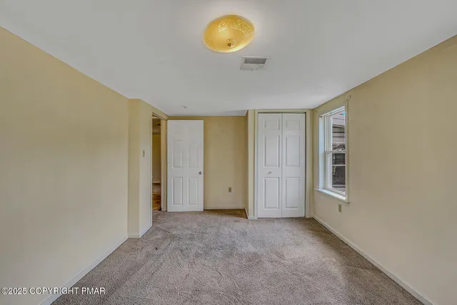 a kitchen with a sink a refrigerator and cabinets