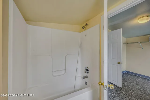 a bedroom with bed and a window