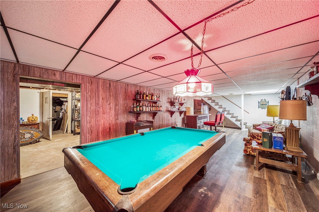 2921 Sexton Road Geneva, OH 44041 - Photo 32 of 43 Recreation room featuring a drop ceiling, pool table, wood finished floors, wood walls, and a bar