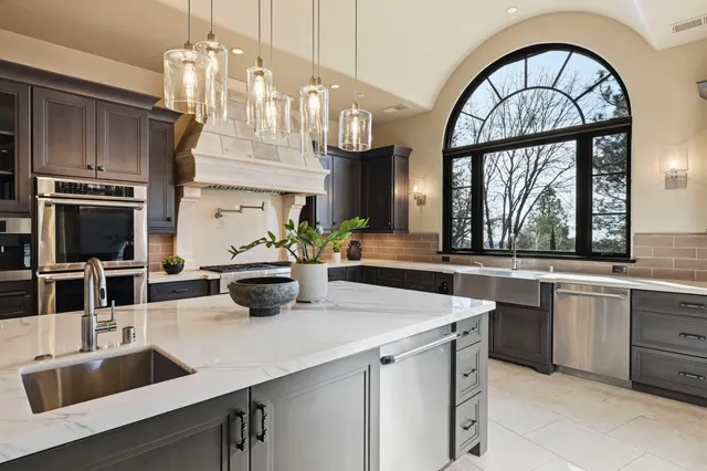 a kitchen with stainless steel appliances granite countertop a stove and a refrigerator