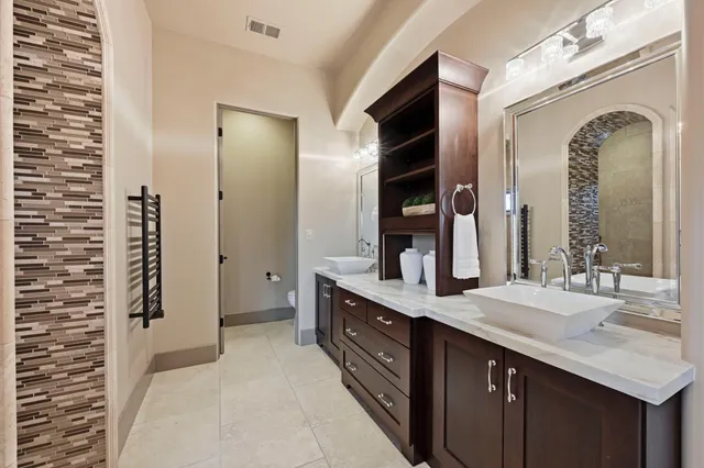 a living room with furniture a bed and a potted plant
