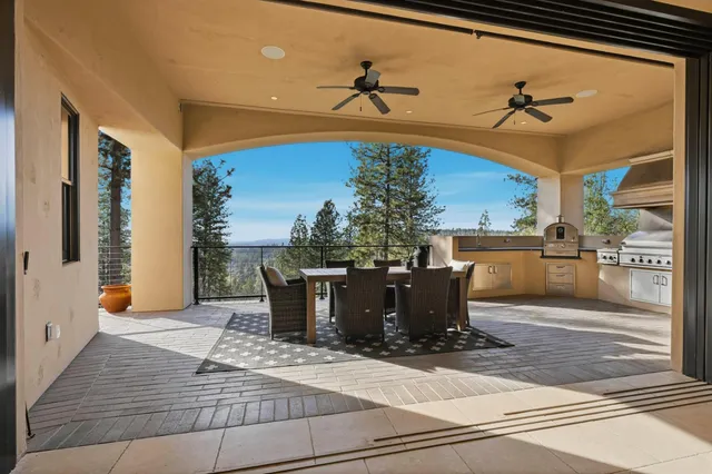 a dining room with wooden floor a chandelier a wooden table and chairs