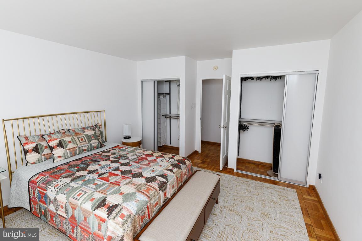 2475 Virginia Avenue Northwest, Unit 515 Washington, DC 20037 - Photo 14 of 22 a bedroom with a bed and painting on the wall