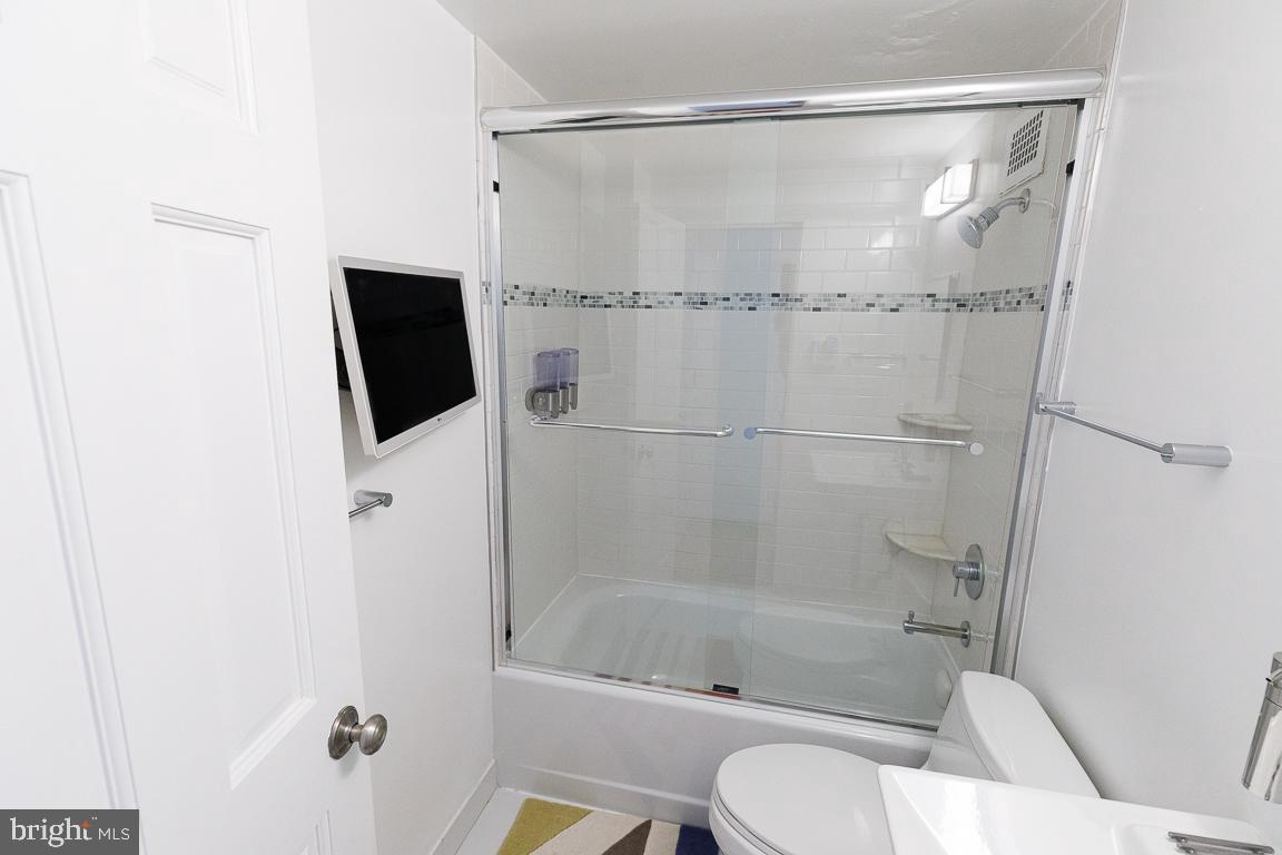2475 Virginia Avenue Northwest, Unit 515 Washington, DC 20037 - Photo 15 of 22 a bathroom with a shower and a toilet