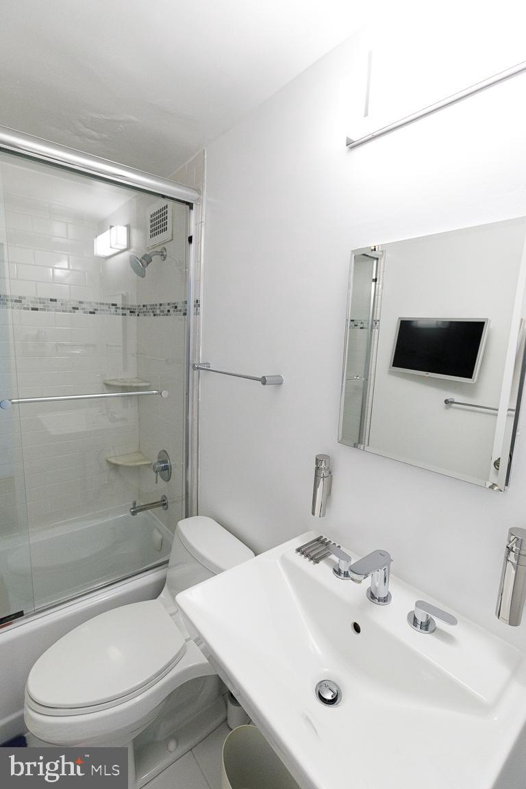 2475 Virginia Avenue Northwest, Unit 515 Washington, DC 20037 - Photo 16 of 22 a bathroom with a sink a toilet and shower