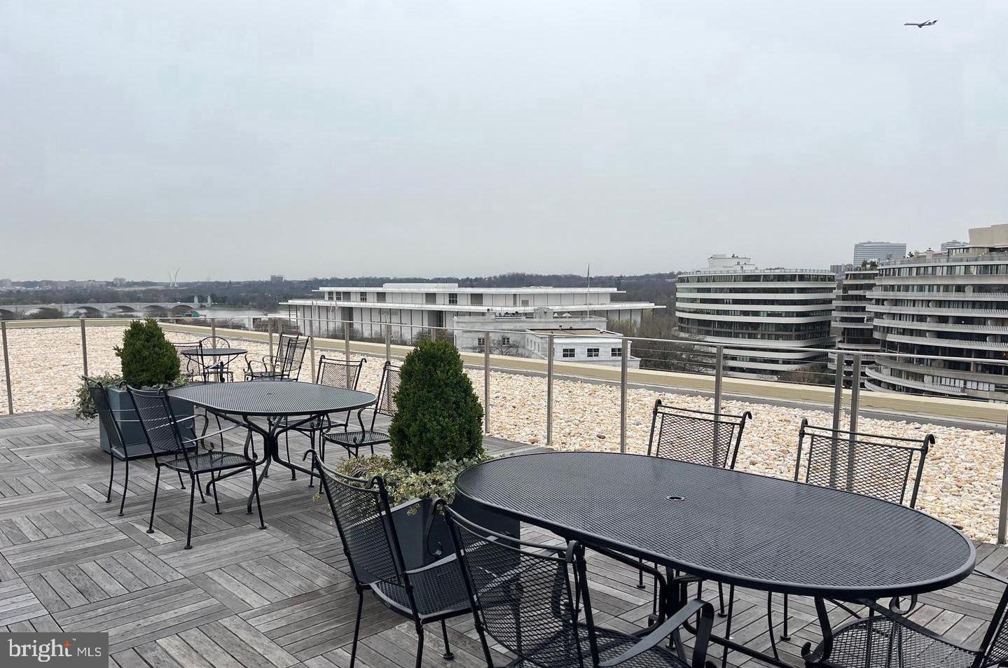 2475 Virginia Avenue Northwest, Unit 515 Washington, DC 20037 - Photo 18 of 22 a view of a chairs and table on the roof deck