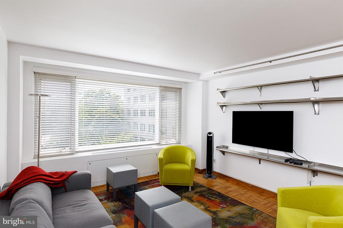 2475 Virginia Avenue Northwest, Unit 515 Washington, DC 20037 - Photo 2 of 22 a living room with furniture and a flat screen tv