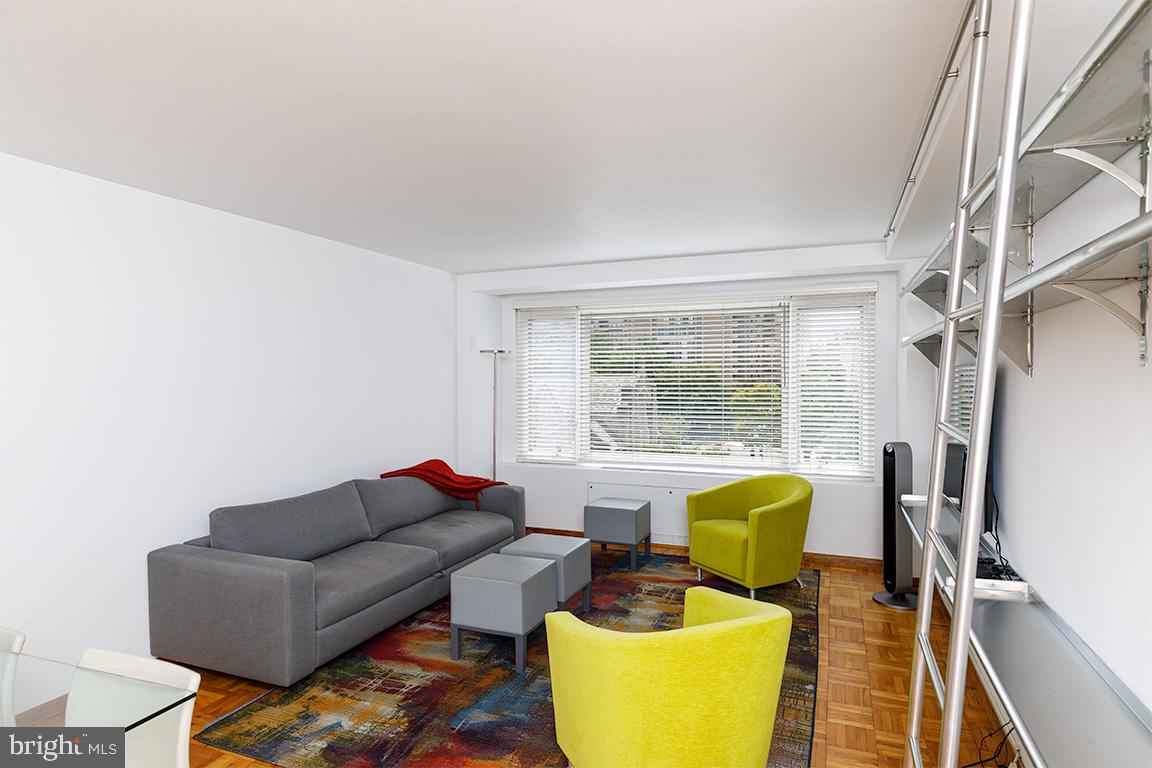 2475 Virginia Avenue Northwest, Unit 515 Washington, DC 20037 - Photo 3 of 22 a living room with furniture and a large window