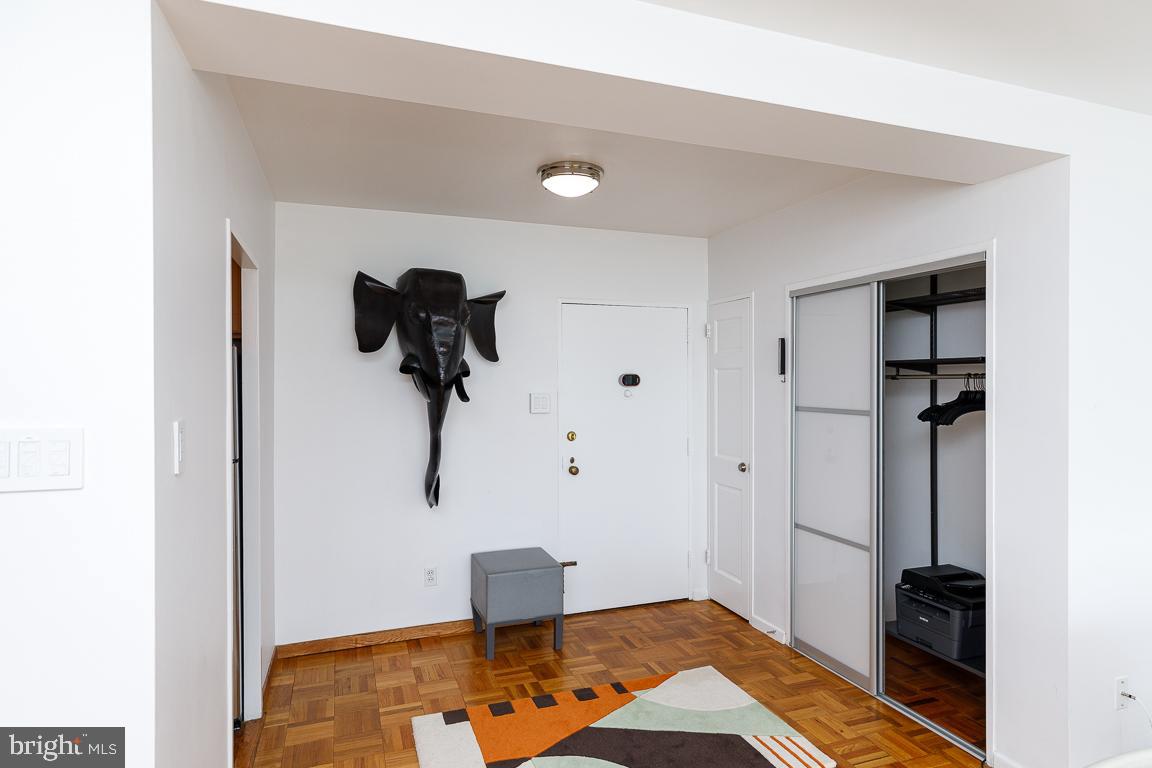 2475 Virginia Avenue Northwest, Unit 515 Washington, DC 20037 - Photo 6 of 22 a bedroom with a bed and a chandelier