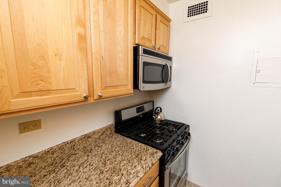 2475 Virginia Avenue Northwest, Unit 515 Washington, DC 20037 - Photo 9 of 22 a kitchen with a stove and a microwave