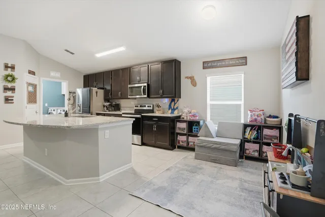 a kitchen with counter top space cabinets and appliances