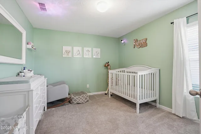 a room with a baby crib and a window
