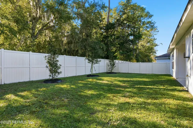 a view of a house with pool and garden