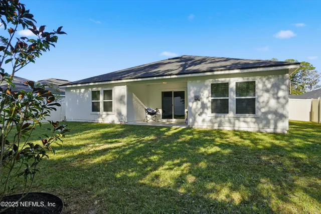 a aerial view of a house with a yard