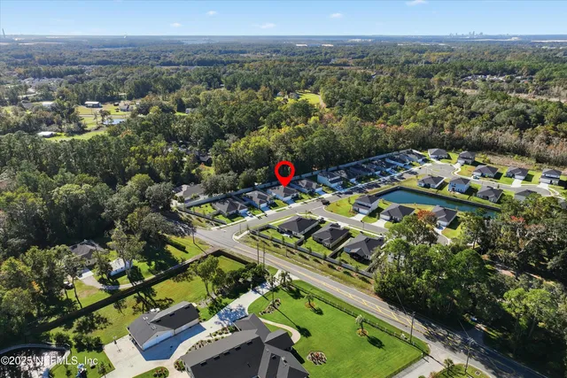 an aerial view of multiple houses with a yard
