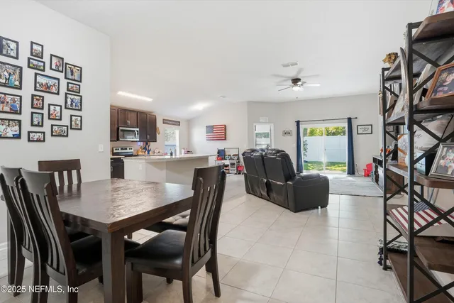 a view of a dining room with furniture and a potted plant