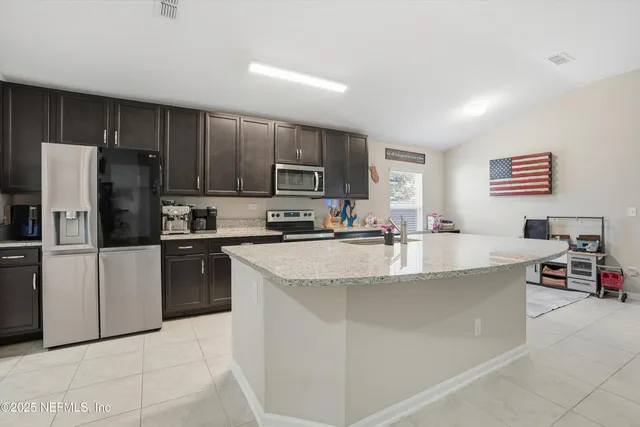 a kitchen with stainless steel appliances and a refrigerator