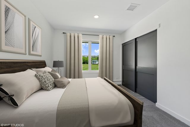 a bedroom with a large bed and a window