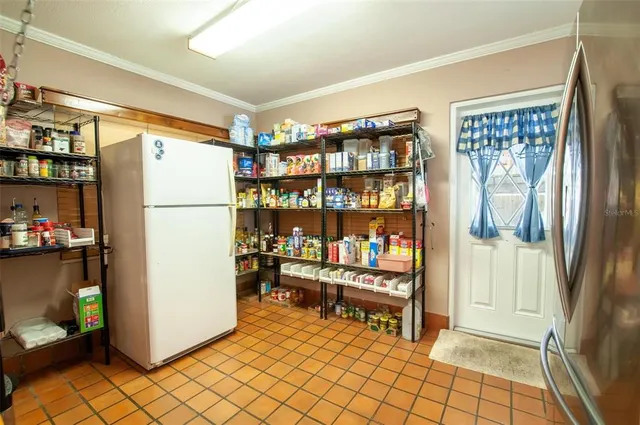 a refrigerator freezer sitting inside of a kitchen