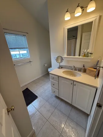 a bathroom with a sink vanity and mirror