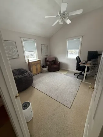 a bedroom with furniture and a window