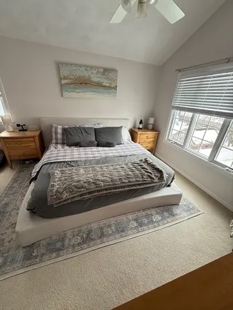 a bedroom with a bed and window