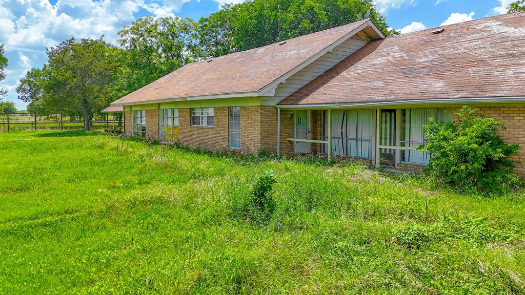 604 Main Street Richland, TX 76681 - Photo 11 of 15 a view of a house with a big yard plants and large trees