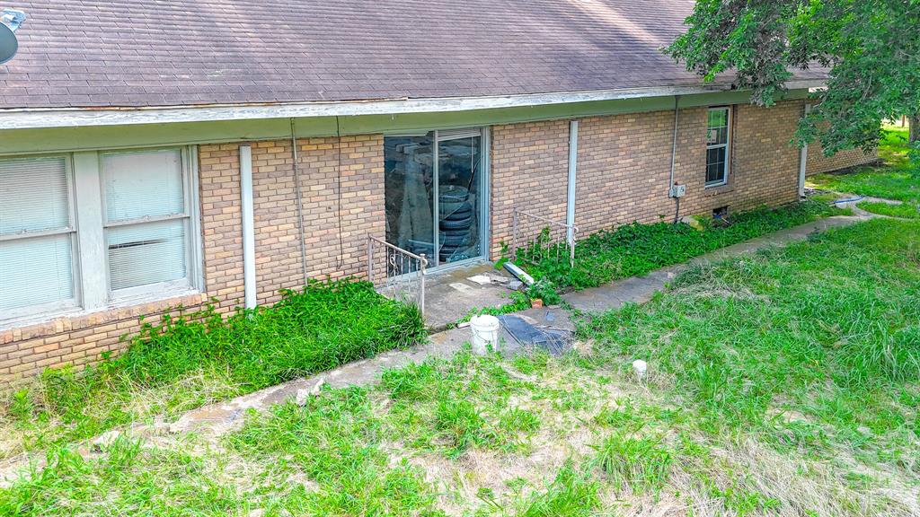 604 Main Street Richland, TX 76681 - Photo 7 of 15 a front view of a house with garden