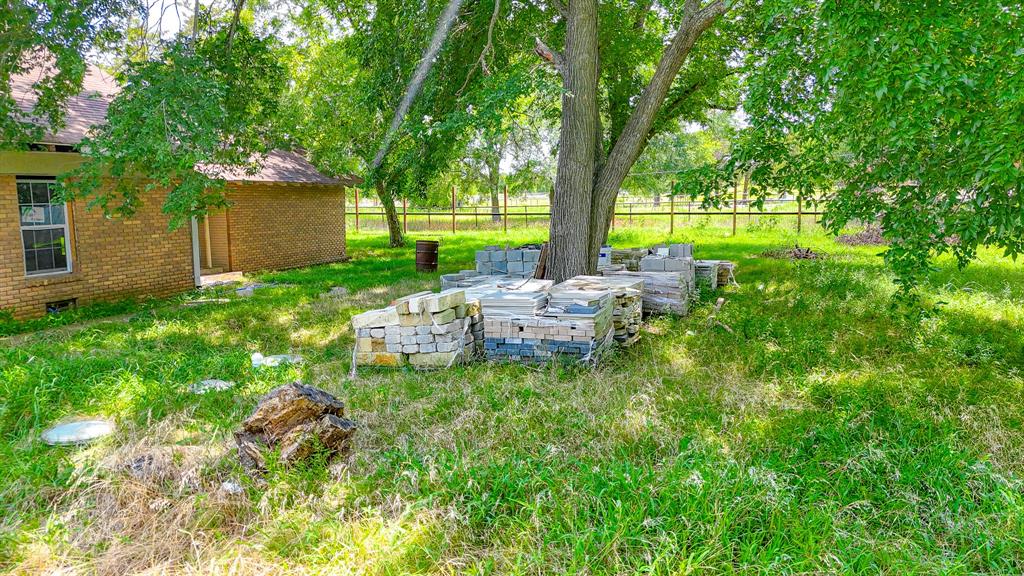 604 Main Street Richland, TX 76681 - Photo 9 of 15 a backyard of a house with yard and outdoor seating
