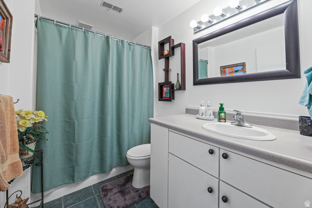 31 Village Square Road Centerville, UT 84014 - Photo 20 of 29 Bathroom featuring a full vanity with an integrated sink, polished chrome faucet, and ample under-sink storage