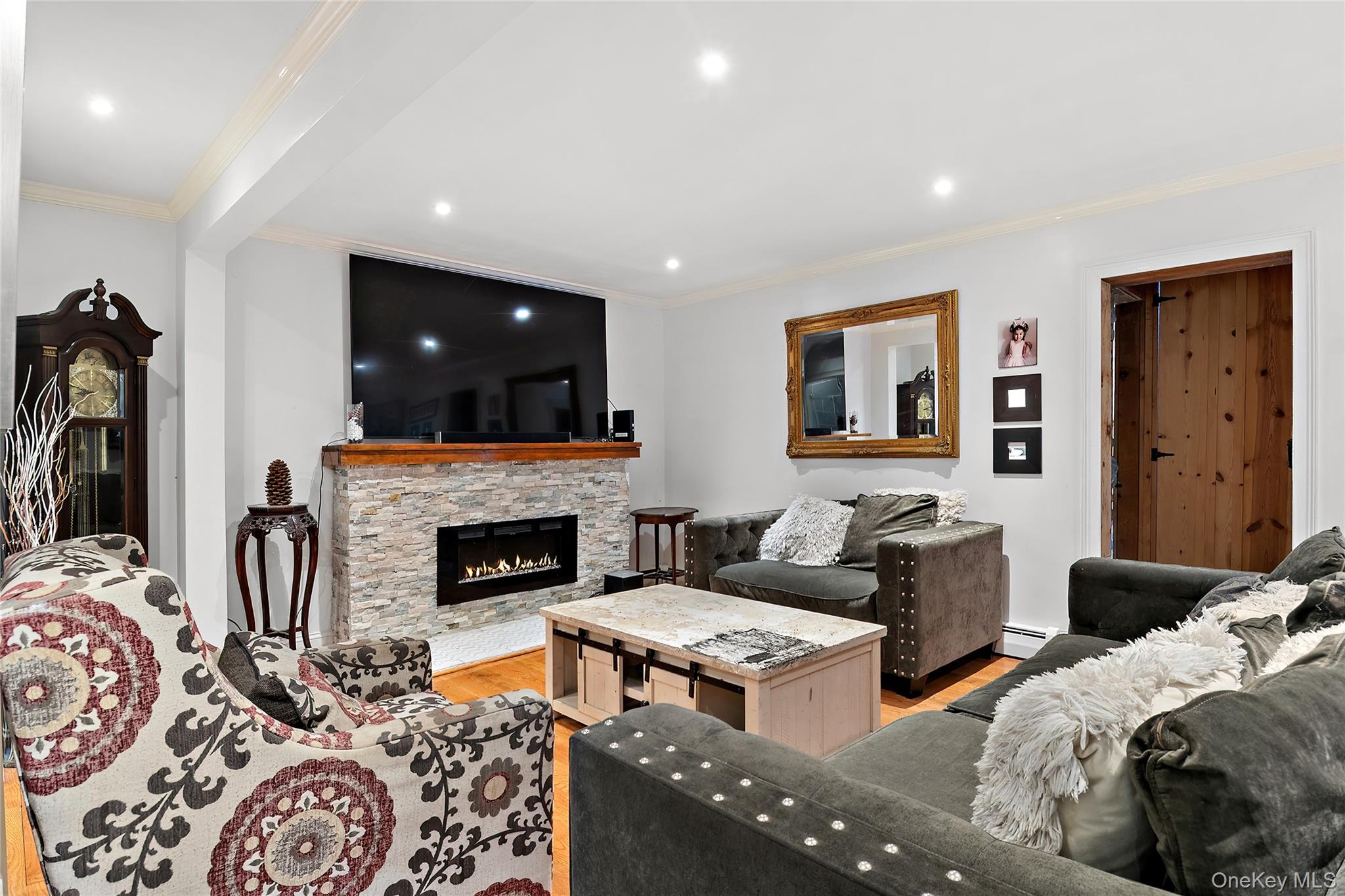 137 South Highland Road Wappingers Falls, NY 12590 - Photo 11 of 39 a living room with furniture a fireplace and a flat screen tv