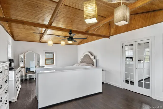 a bedroom with a bed and a mirror