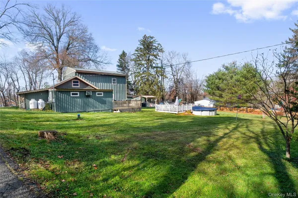 a view of a house with a yard patio and fire pit