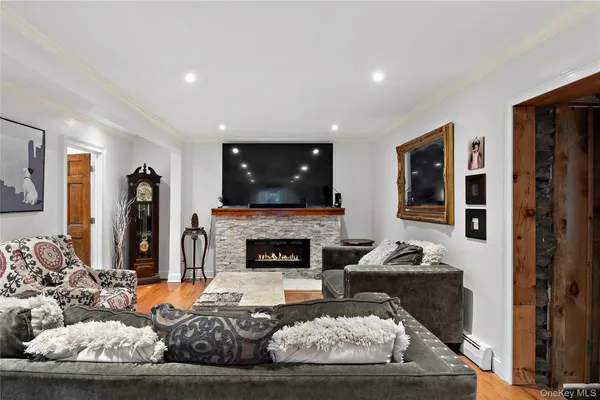 a living room with furniture a fireplace and a flat screen tv