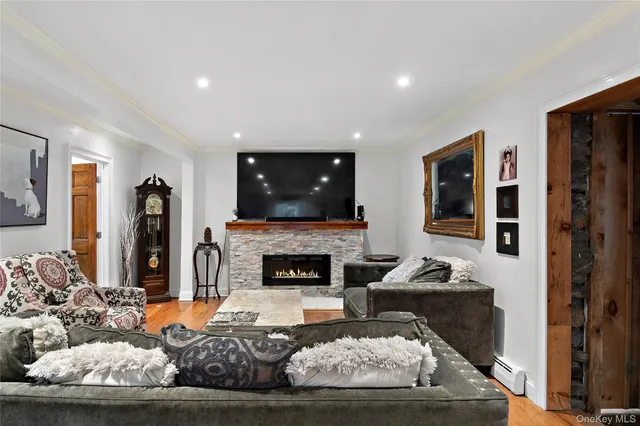 a living room with furniture a fireplace and a flat screen tv