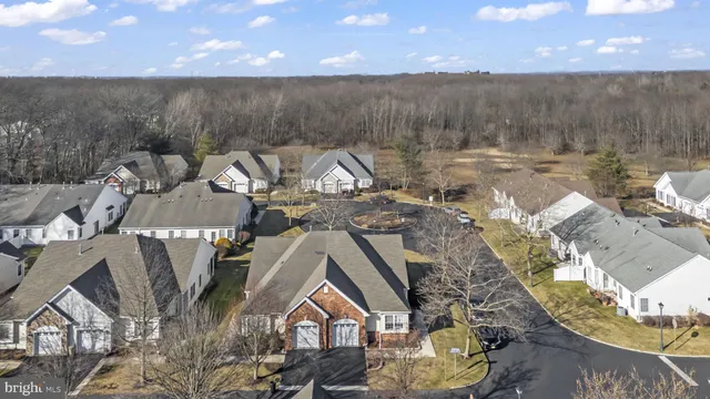 a view of a house with a yard and sitting area