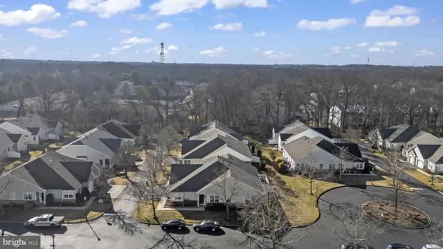 an aerial view of a house with a mountain