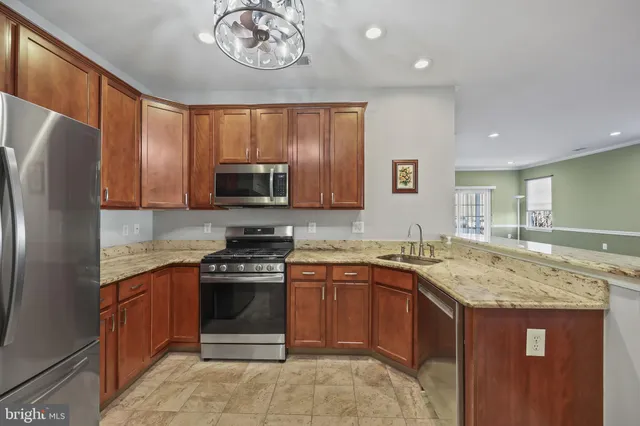 a kitchen with a sink stove top oven and refrigerator