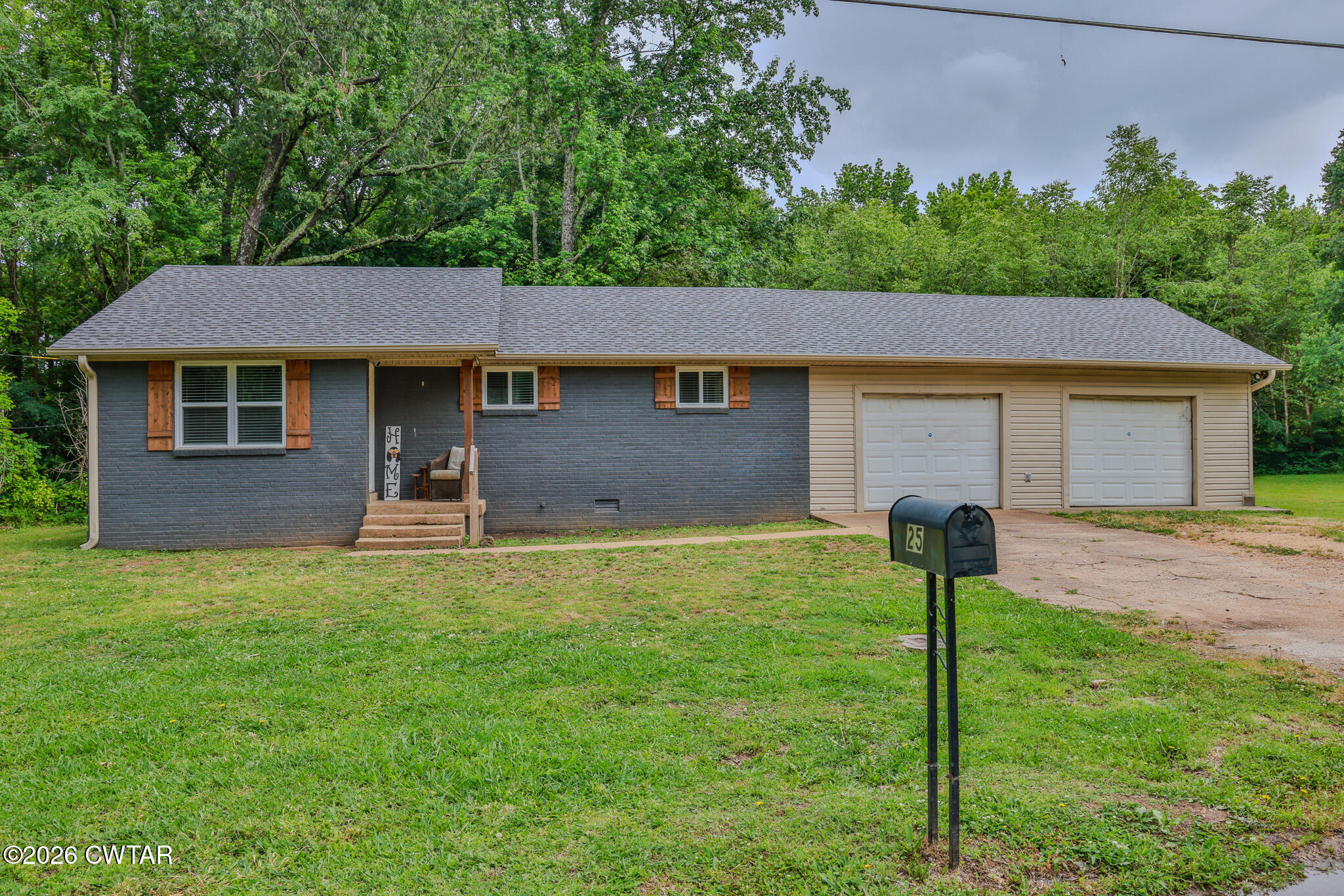 25 Shady Lane Huntingdon, TN 38344 - Photo 1 of 16 a front view of a house with a garden and yard