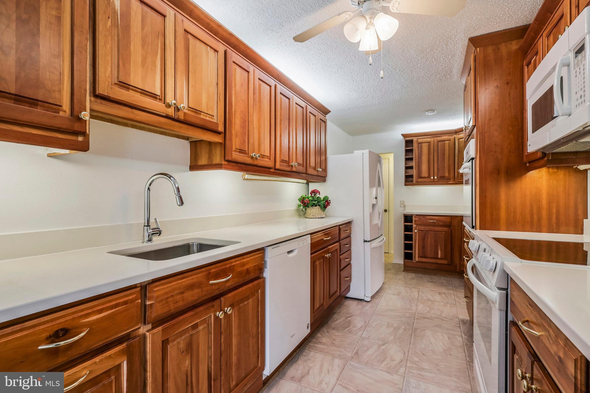 6101 Edsall Road, Unit 712 Alexandria, VA 22304 - Photo 12 of 53 a kitchen with stainless steel appliances granite countertop a sink and dishwasher a stove top oven with wooden floor