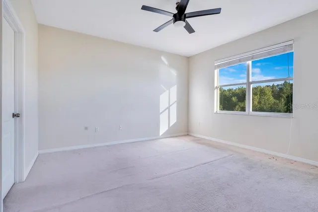 a view of a livingroom with a ceiling fan and window